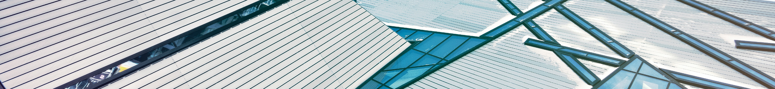 A background banner, looking up into the sky, of a space between two gray buildings.