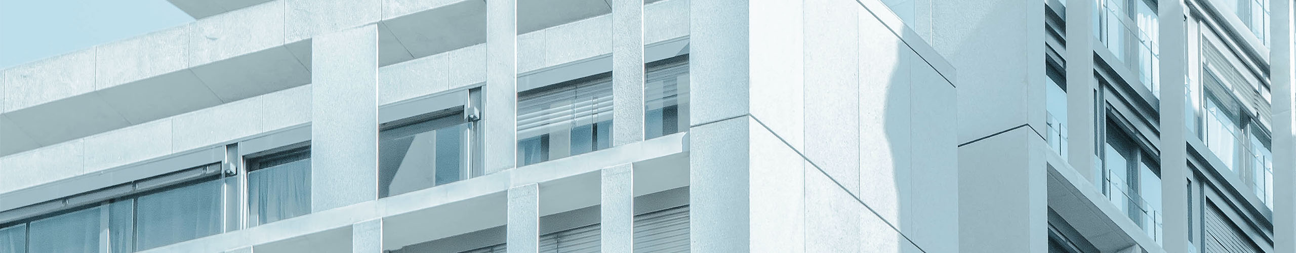 A background banner of a gray business building with many windows.