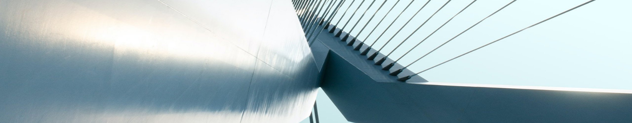 A background banner, looking up into the sky, of a space between two gray buildings.